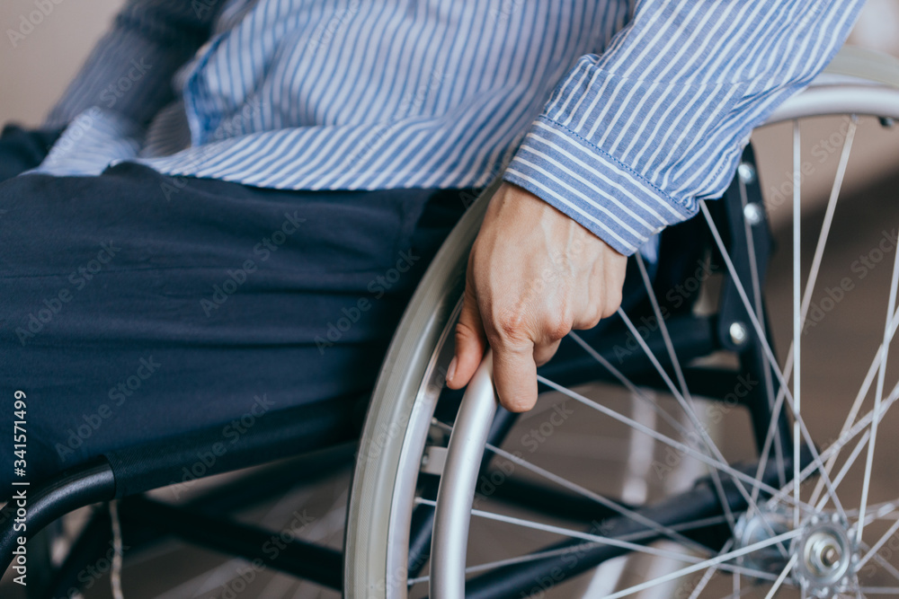 Obraz premium Unrecognizable disabled woman in wheelchair at home. Recovery and healthcare concepts.