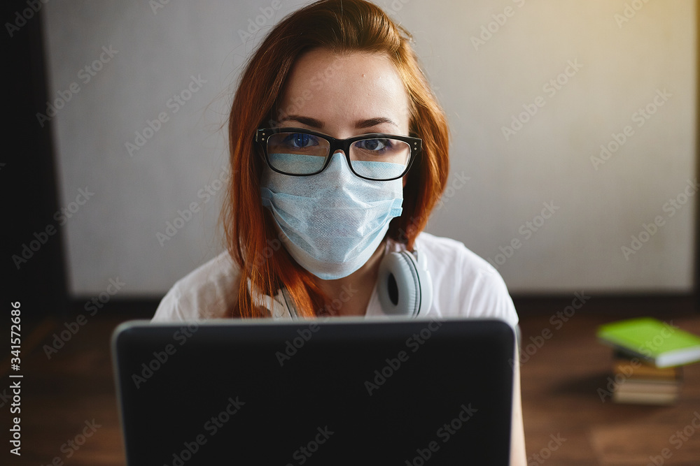 Woman working from home wearing protective mask. Student in quarantine for coronavirus wearing protective mask. Working from home Woman working from home wearing protective mask. Student in quarantine for coronavirus wearing protective mask. Working from home