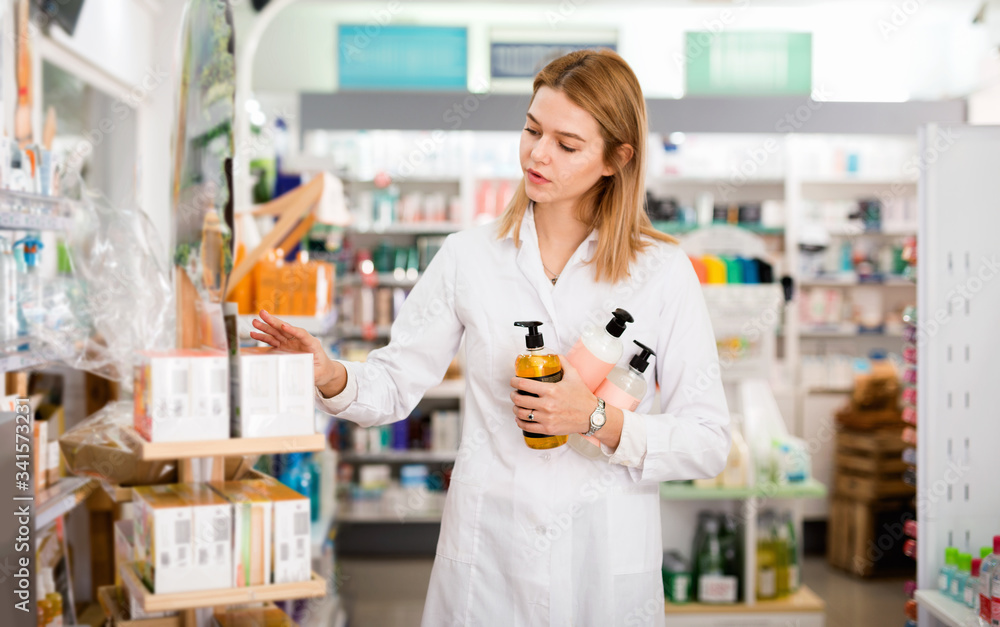Female pharmacist searching for reliable body care products in pharmacy
