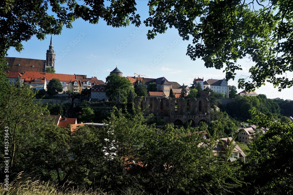 The old town of Bautzen hidden behind trees and bushes