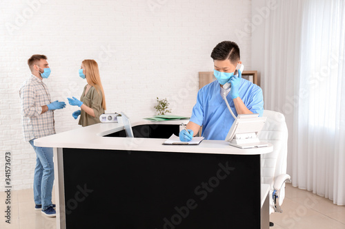 Asian male receptionist wor...