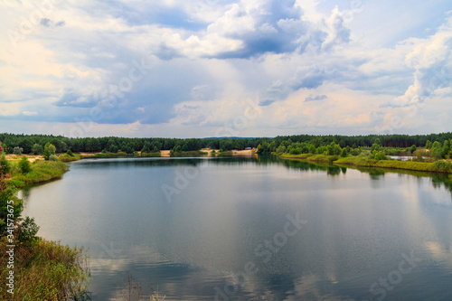 View of a beautiful lake in a pine forest at summer