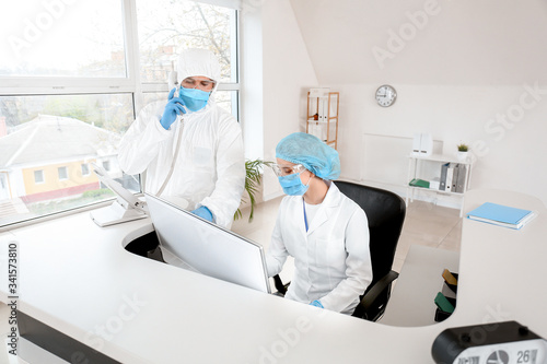 Receptionist with doctor in...