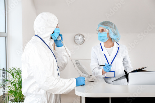 Receptionist with doctor in...