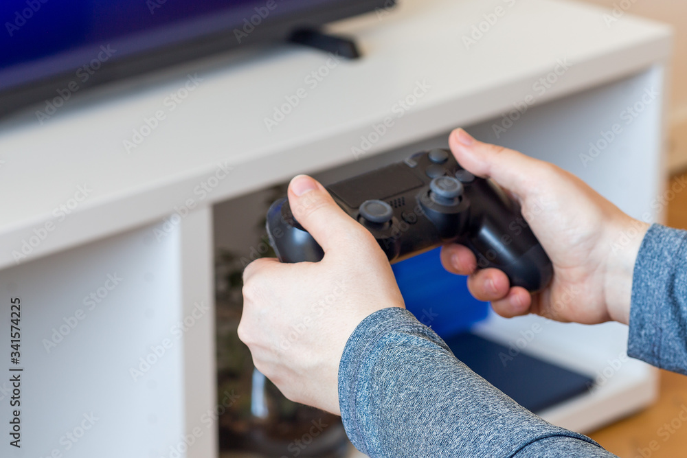 Woman hands with a game controller, relaxation at home, closeup Woman hands with a game controller, relaxation at home, closeup