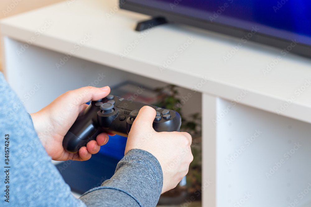 Woman hands with a game controller, relaxation at home