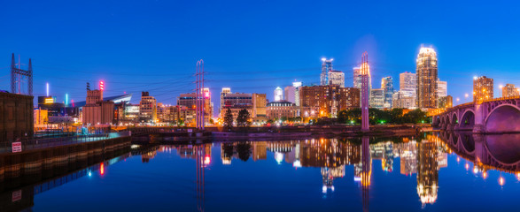 Minneapolis skyline with reflection in river at night.