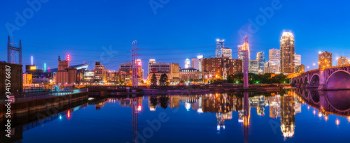 Minneapolis skyline with reflection in river at night.
