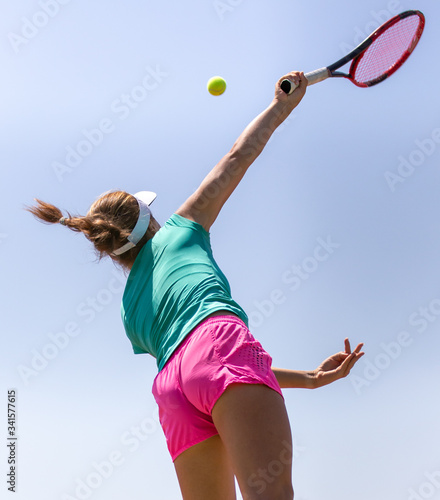Girl plays tennis on the court in the park © schankz