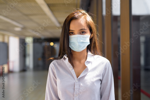 Young Asian tourist woman with mask for protection from corona virus outbreak at the airport
