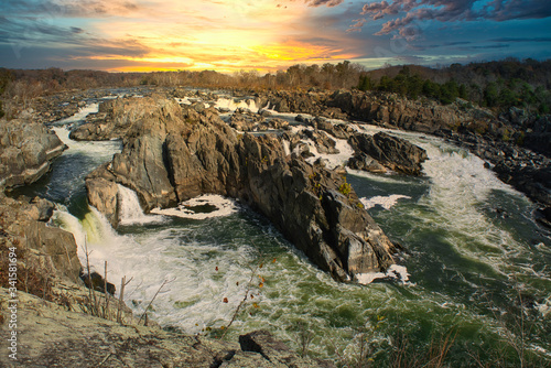 Potomac River waterfalls panorama in Great Falls state park in Virginia, USA. Great Falls state park at sunset in autumn with birds of prey circling above the rapids. photo