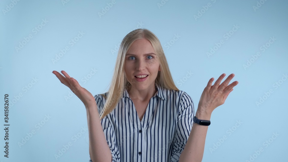 Cheerful blonde woman coming to an excellent idea after a minute of thinking on blue background. Cheerful blonde woman coming to an excellent idea after a minute of thinking on blue background.