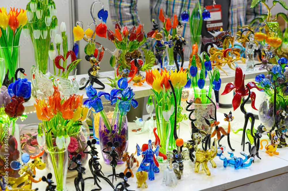 Fototapeta premium Flowers and figures made of colored glass. Sale of products from glass are handmade.