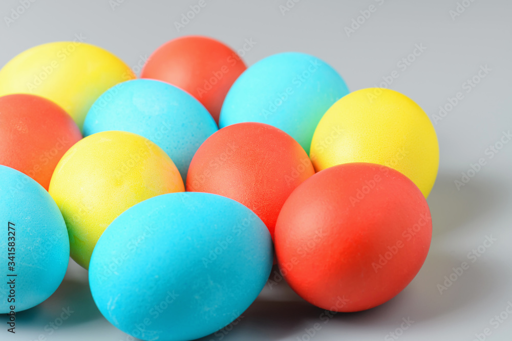 Colorful Easter eggs on a gray background. Easter eggs background. Easter eggs are a symbol and a mandatory attribute of the holiday. Colorful Easter eggs on a gray background. Easter eggs background. Easter eggs are a symbol and a mandatory attribute of the holiday.