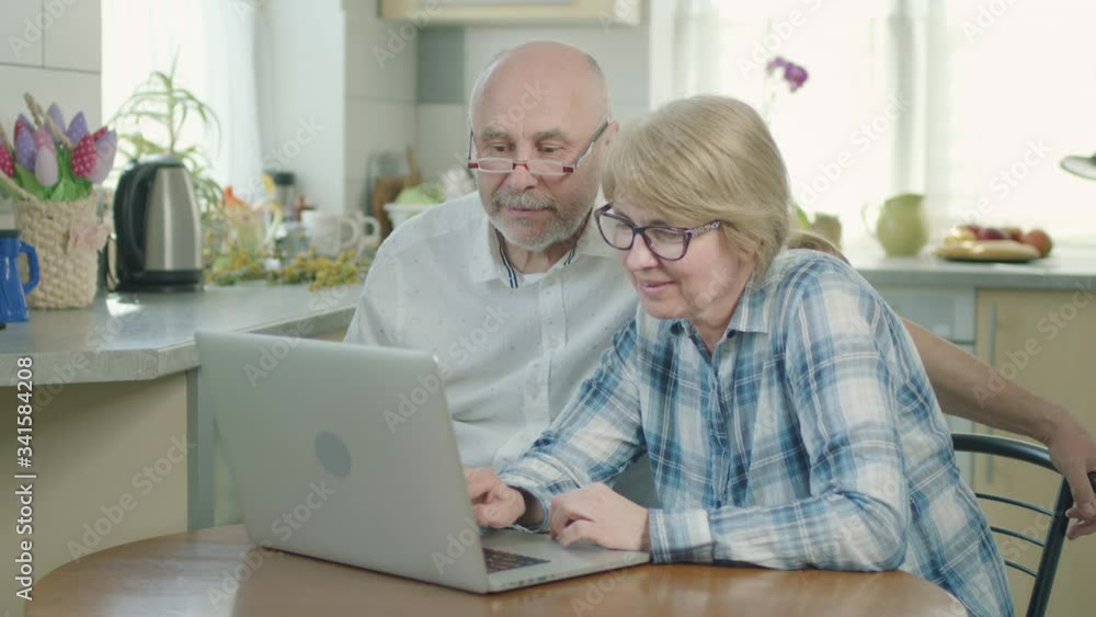 Mature Couple Man And Woman Sitting At Laptop. Mature Couple Man And Woman Sitting At Laptop.