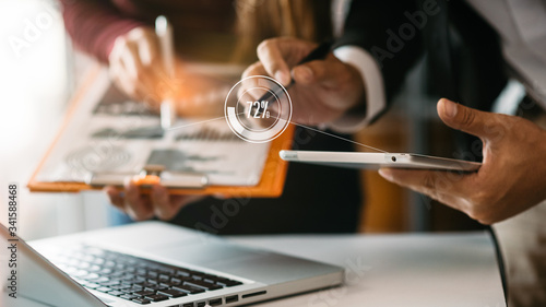 Business and office concept,Close-up hand businessman,business team work planning using tablet and laptop online at office blurred background.