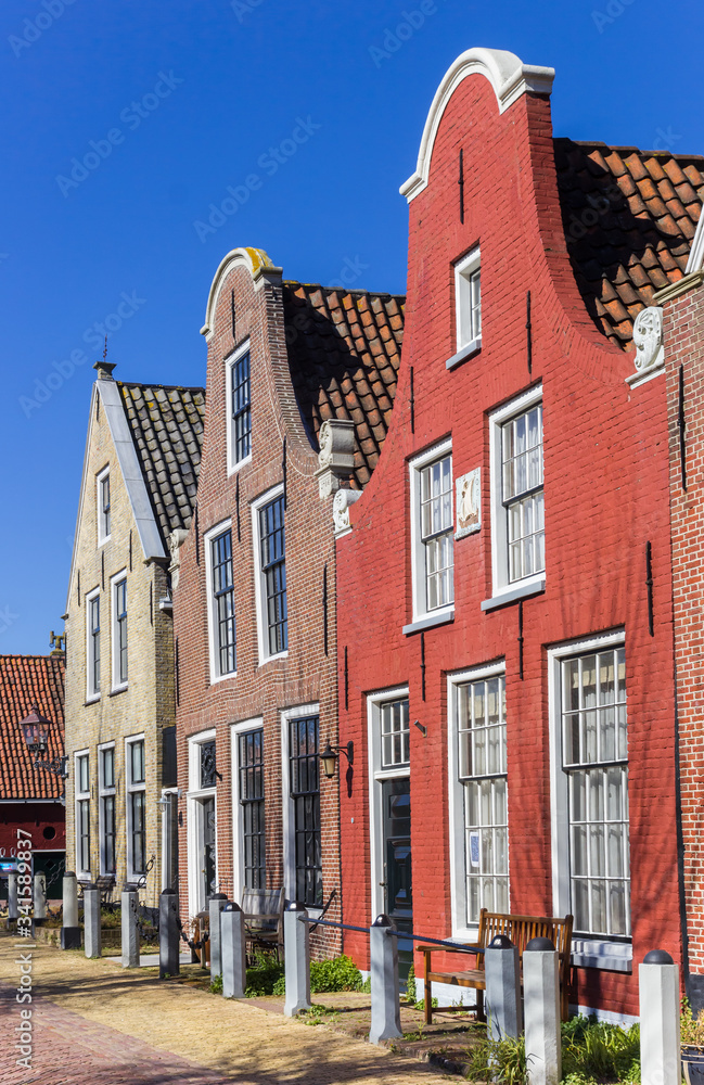 Fototapeta premium Red brick house with clock gable in Harlingen, Netherlands