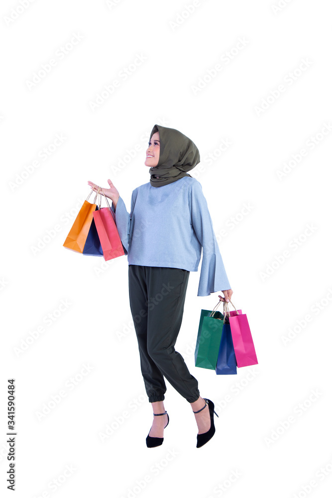 beautiful women of Muslim Indonesia is holding a shopping bag with a joyful expression isolated on background