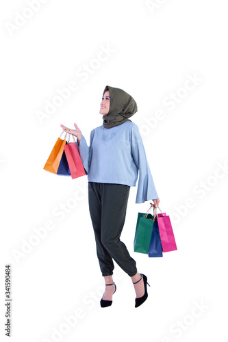 beautiful women of Muslim Indonesia is holding a shopping bag with a joyful expression isolated on background