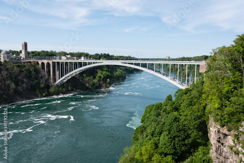 Rainbow Bridge over river with blue sky, Niagara falls, USA and Canada Border