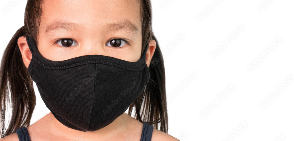 Portrait of Asian child girl wearing facial mask for protection from air pollution or virus epidemic on white background. Health care concept. Portrait of Asian child girl wearing facial mask for protection from air pollution or virus epidemic on white background. Health care concept.