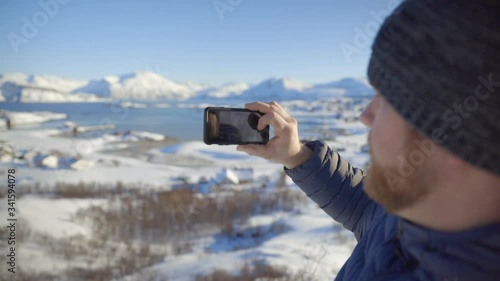 A Man Taking a Picutre with His Phone of an Amazing Winter Landscape, Slow Motion photo