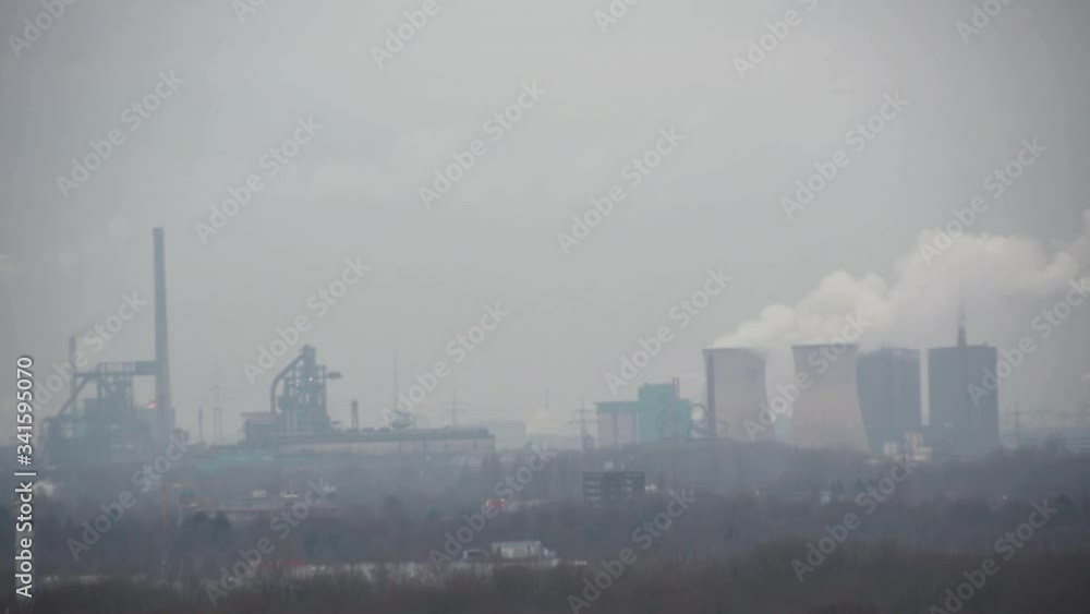 View of industrial plants working and emitting smoke into the air View of industrial plants working and emitting smoke into the air