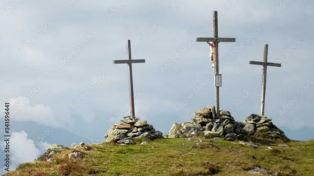 Timelapse of three large crucifixes on top of a mountain. Timelapse showing three large Christian crosses being held by large stone piles at the peak of a mountain during a cloudy day Timelapse of three large crucifixes on top of a mountain. Timelapse showing three large Christian crosses being held by large stone piles at the peak of a mountain during a cloudy day