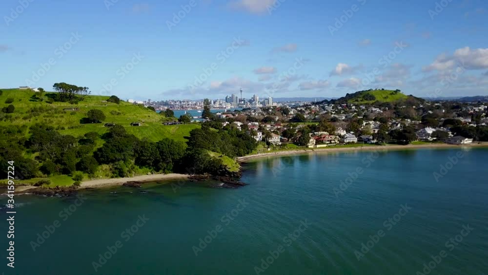 Flying over a beautiful beach with the Auckland skyline in the distance. New Zealand paradise. Flying over a beautiful beach with the Auckland skyline in the distance. New Zealand paradise.