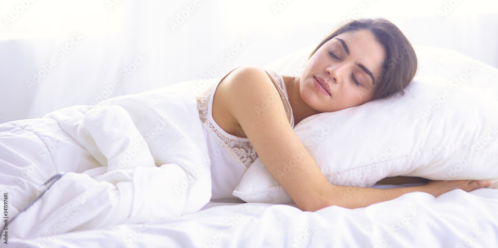beautiful young woman basking in bed in the morning. Beautiful beautiful young woman basking in bed in the morning. Beautiful