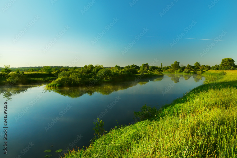 River with green banks in springtime.