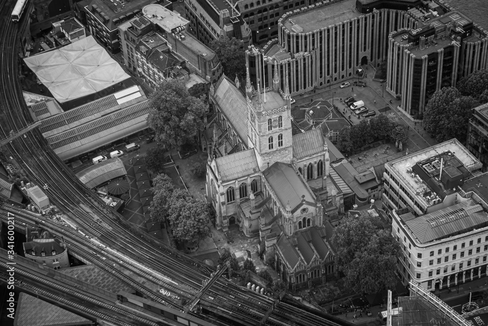 Aerial view of London, UK. church and railway going through the city in black and white