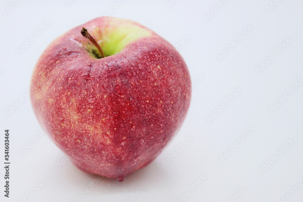 Delicious ripe red juicy beautiful apple located on a white background Delicious ripe red juicy beautiful apple located on a white background