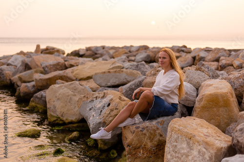 Blonde model on the beach at summer