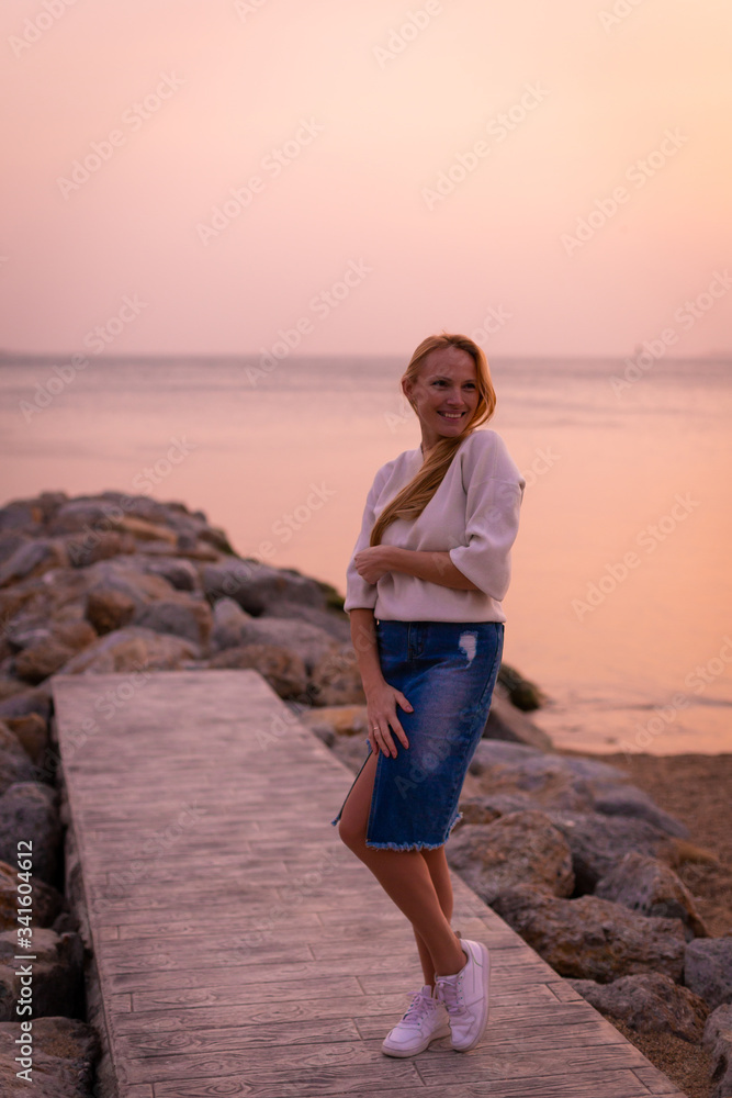 Blonde model on the beach at summer