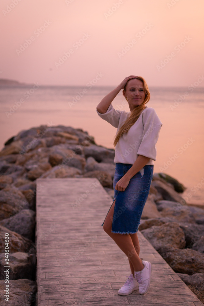 Blonde model on the beach at summer
