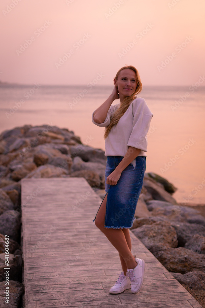 Blonde model on the beach at summer