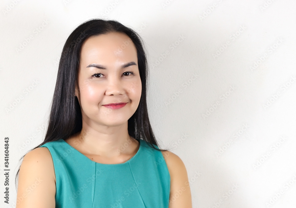Asian woman with long black hair wearing green sleeveless blouse , smiling and looking at camera. Asian woman with long black hair wearing green sleeveless blouse , smiling and looking at camera.