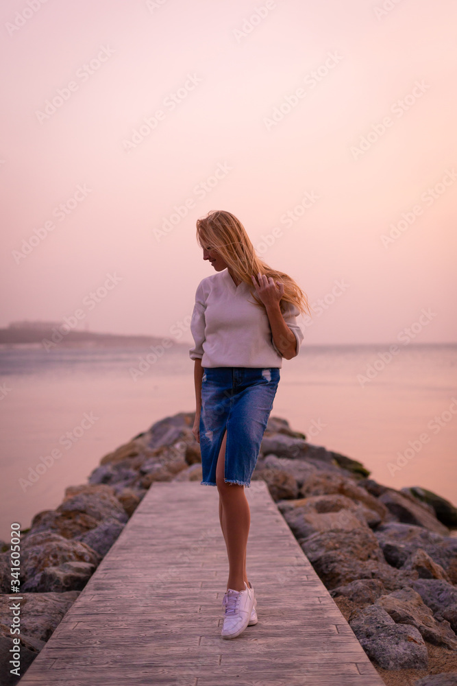 Blonde model on the beach at summer