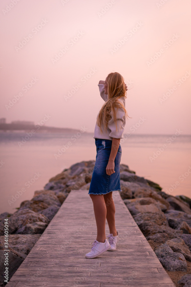 Blonde model on the beach at summer