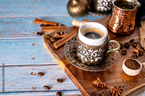 Arabian coffee cup on a traditional serving wood