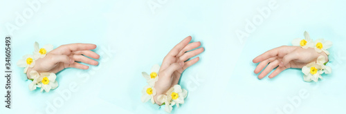 Collage Hands with spring flowers sticking out of hole  torn paper background.Cosmetics hand skin care and wrinkle reduction.Skincare and moisturizing concept. Beauty, fashion panoramic