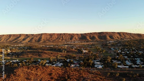 Left Trucking Drone Shot of the mountains and town in Alice Springs, Australia