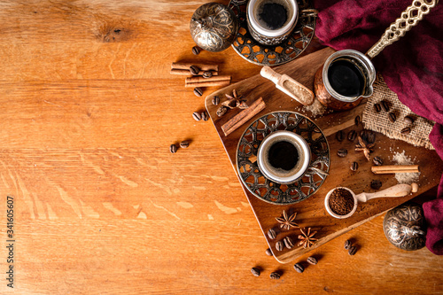 Top down view of a coffee table arrangement on wood background with space for text