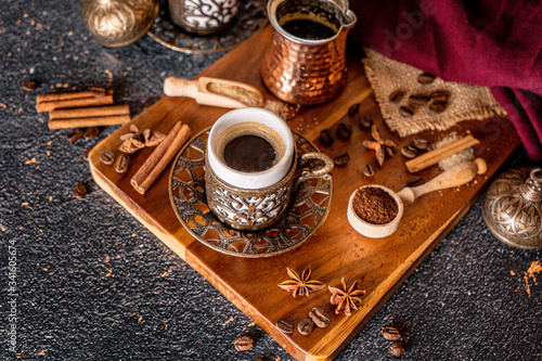 Cup of aromatic coffee drink and coffee beans on wooden background. Top view
