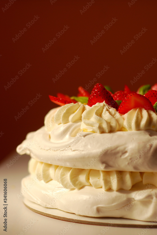 Pavlova meringue cake with strawberries, cream and basil Pavlova meringue cake with strawberries, cream and basil