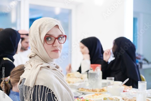 young muslim woman having Iftar dinner with family