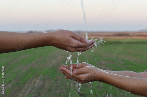 hands watered against a field