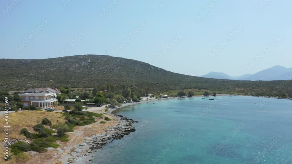 The seaside road by the waves and green mountain of the Eubea Island in Greece - aerial The seaside road by the waves and green mountain of the Eubea Island in Greece - aerial