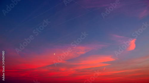 Sunset with pink clouds, light rays and other atmospheric effect.
